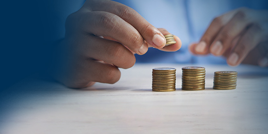 person stacking coins