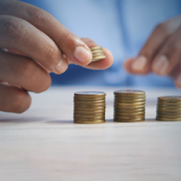 person stacking coins