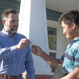 Cameron Walker handing house keys to client
