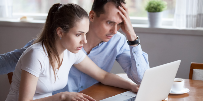 frustrated couple in front of computer