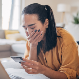 Concerned woman realizing she's being scammed by a bank imposter