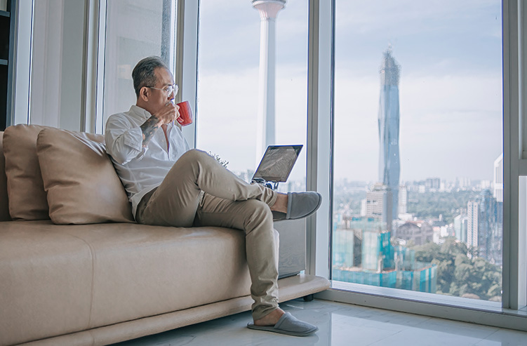 man enjoying his coffee by the window