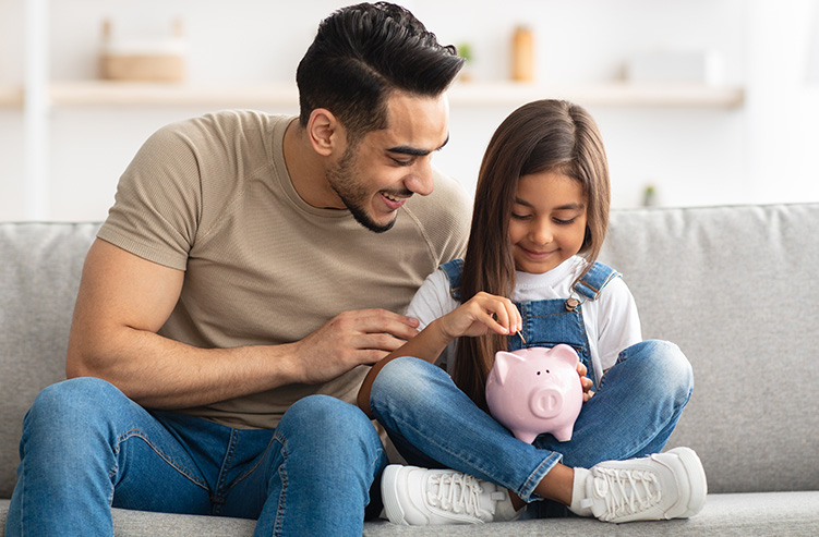 dad with kid and piggy bank