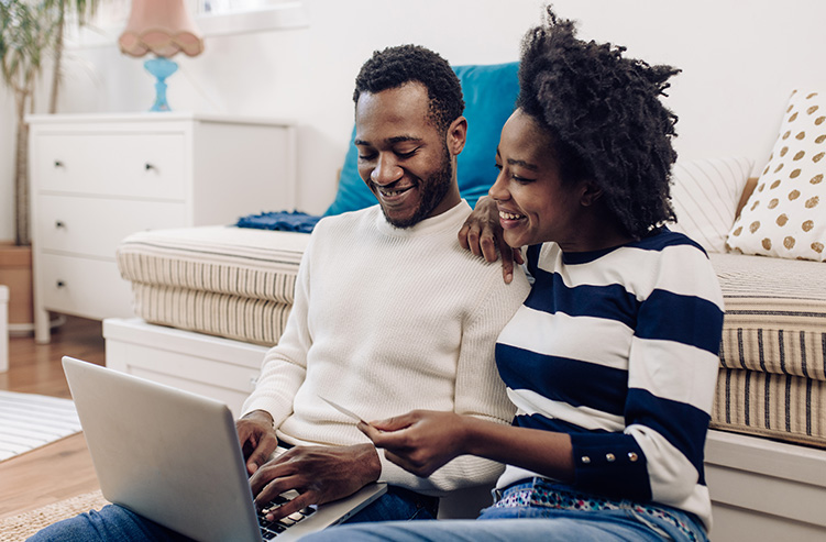 couple sitting looking at online banking